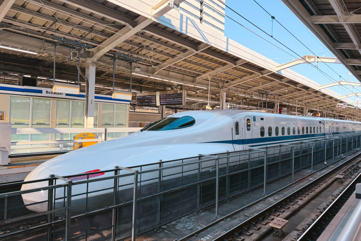 A shinkansen bullet train waiting at a station platform in Japan