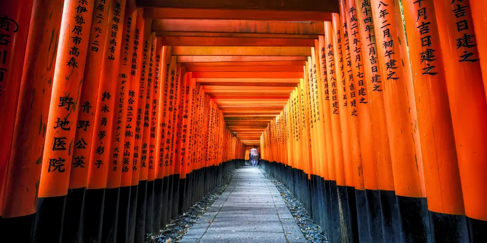 A tunnel of vermilion torii gates at Fushimi Inari shrine in Kyoto